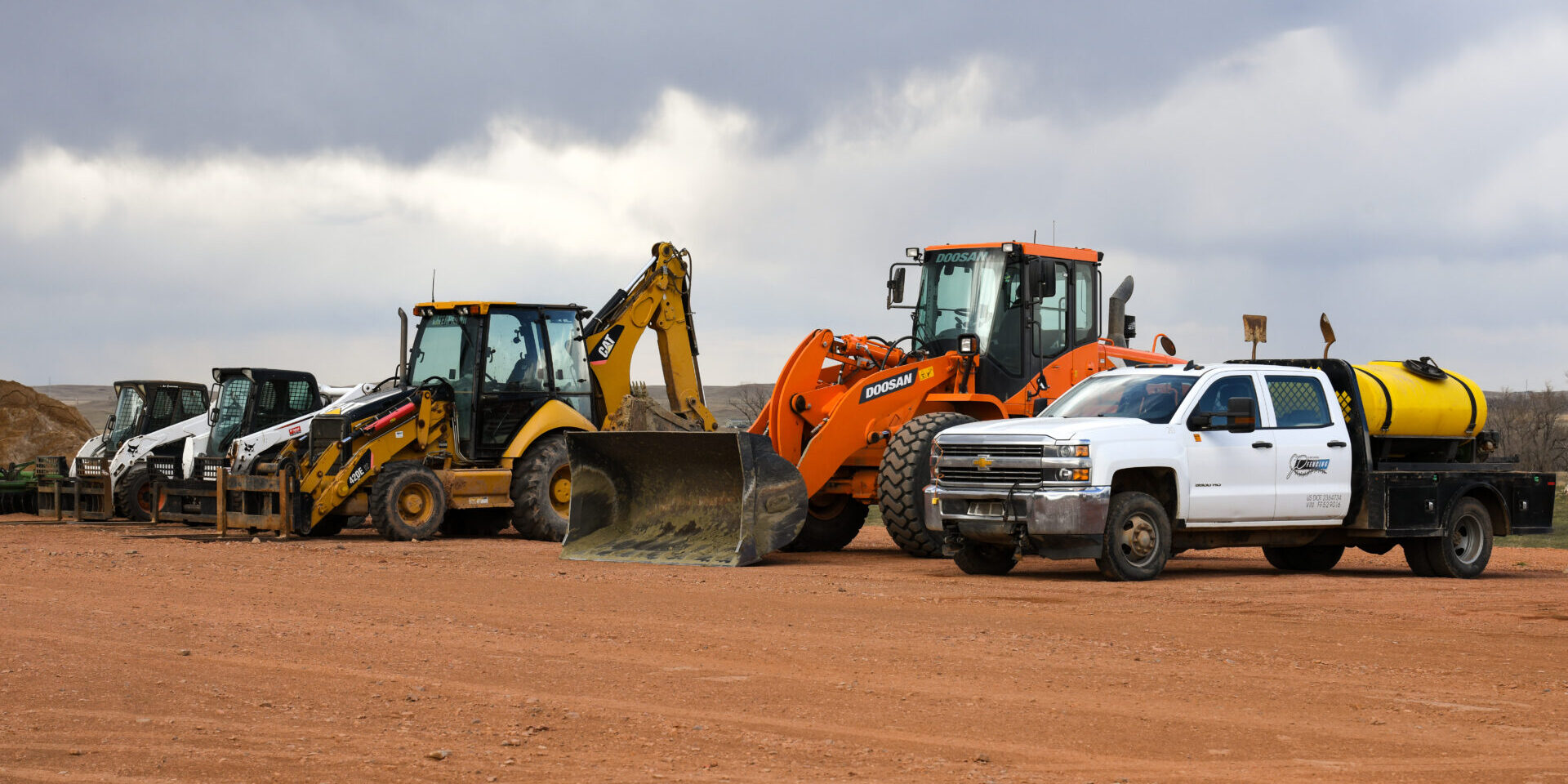 A couple of large construction vehicles are on the ground